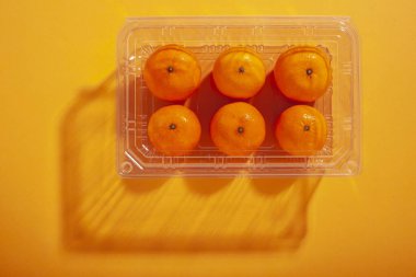 Plastik bir kapta portakallar