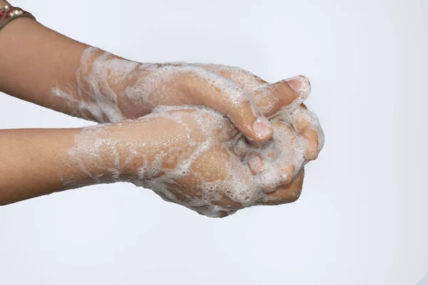An asian girl washing hands with soap isolated with white background. Hygiene concept.To prevent from corona virus (covid-19). Selective focus.