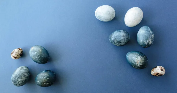 Belo grupo ombre azul ovos de Páscoa com ovos de codorna e penas em um fundo azul. Conceito de Páscoa. Ovos de fronteira. Espaço de cópia para texto . — Fotografia de Stock