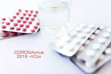 Pills on the table with a glass of water. medical topics. virus and coronovirus. top view, place for text.