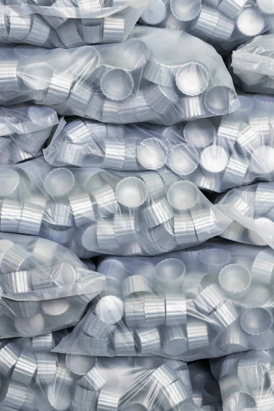 gray plastic bottle caps in plastic bag