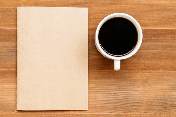 Blank cover book and cup of black coffee on brown wooden backgro — Stock Photo, Image