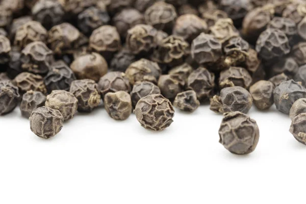 Black peppercorns on white background — Stock Photo, Image