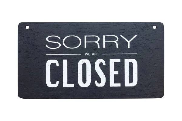 front view of Sorry we are closed sign on black wooden board isolated on white backgroun