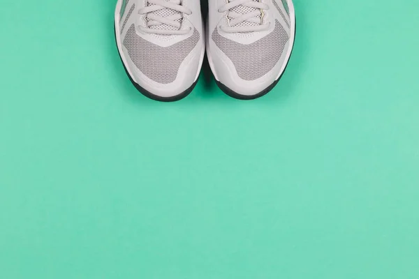 Grey sneakers on the turquoise background. Concept for healthy lifestyle and everyday training. — ストック写真