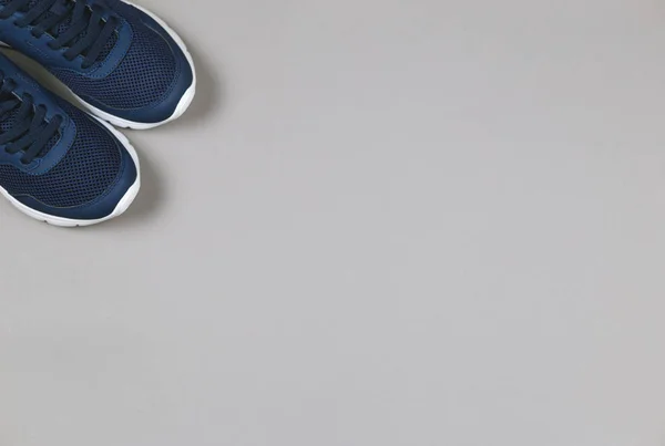 Zapatillas clásicas azules sobre fondo gris. Concepto para un estilo de vida saludable y entrenamiento diario . — Foto de Stock