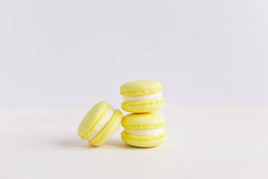 Beyaz ahşap arka planda sarı franch kurabiyeleri. Limonlu kurabiye. Metin için yer.