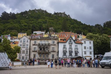Sintra, Portekiz - 30 Haziran 2018: Turistler bir yaz günü Sintra 'nın fayanslı ve tepelik caddeleri boyunca sıralanmış mağazalarda dururlar. 