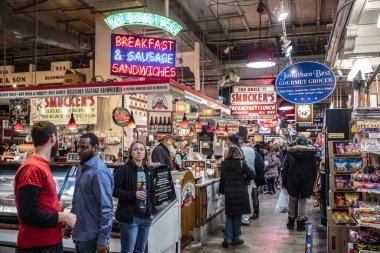 Philadelphia, PA/USA-Feb 29, 2020: Patrons shop at the Reading Terminal Market, an enclosed public market located at Center City Philadelphia. It opened originally in 1893 under the elevated train shed of the Reading Railroad Company.