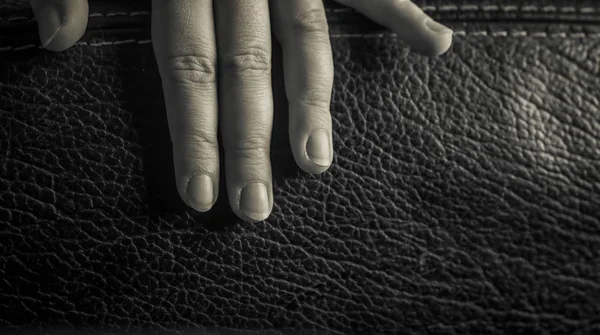 Közelkép Egy Ujjairól Egy Bőrszéken Fekete Fehérben — Stock Fotó
