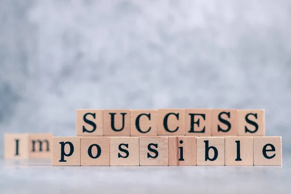 Wood cube letter word of possible and success. Idea of motivation and inspiration in business vision and corporate management strategy. Leadership lead teamwork to reach achievement.