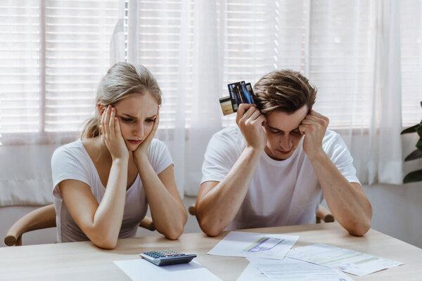 Stressed caucacian couple conclict of credit card bills or bebt of over expense in shopping. Lover financial risk or crisis and bad habits of shopaholic. Lack of money discipline, planning and advisor