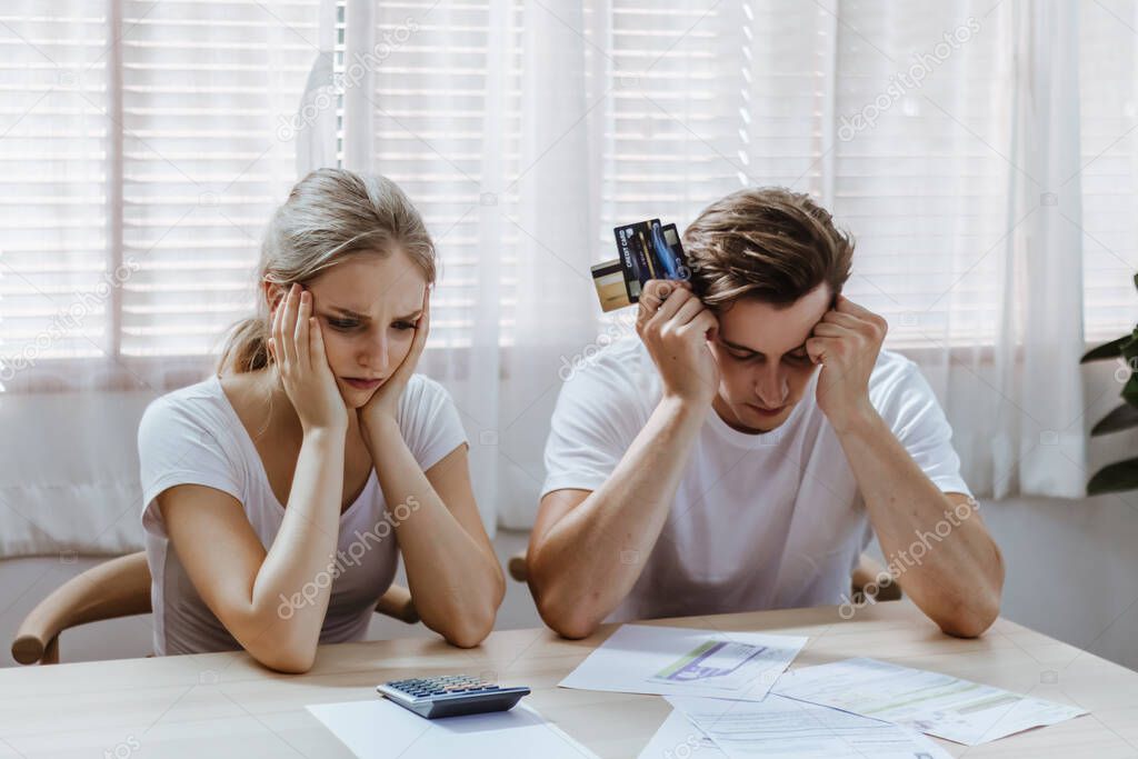 Stressed caucacian couple conclict of credit card bills or bebt of over expense in shopping. Lover financial risk or crisis and bad habits of shopaholic. Lack of money discipline, planning and advisor