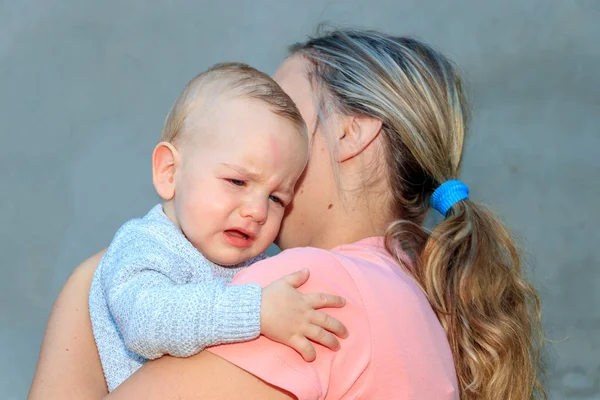 Portrait of a crying baby. The baby boy cries in his mother's embrace. Emotion, love — Stock Photo, Image