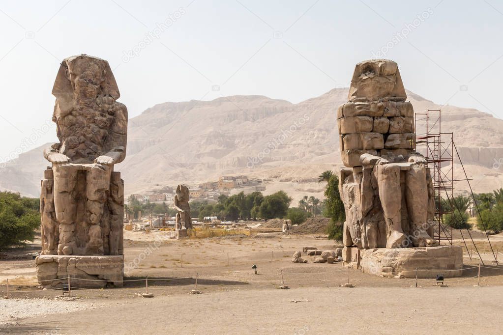 Two stone statues of Pharaoh Amenhotep III at Theban Necropolis, Luxor, Egypt