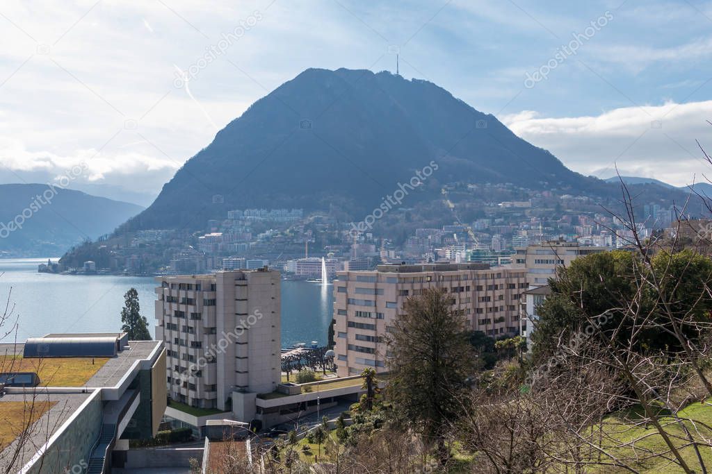 Buildings at Lake Lugano and mountains in Lugano, Ticino canton of Switzerland