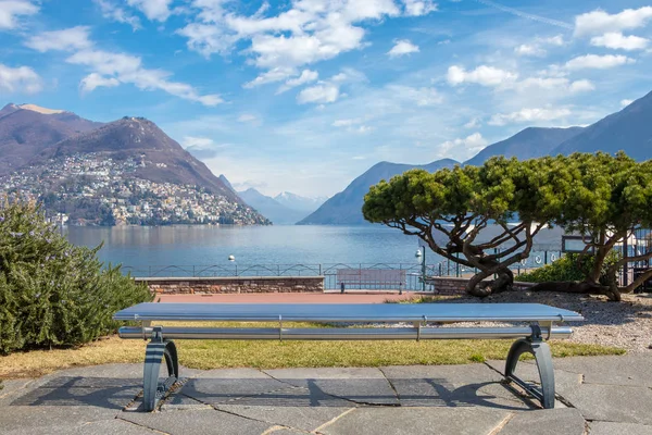 The bench at the Lake Lugano and Alps mountains in Ticino canton of Switzerland — Stock Photo, Image
