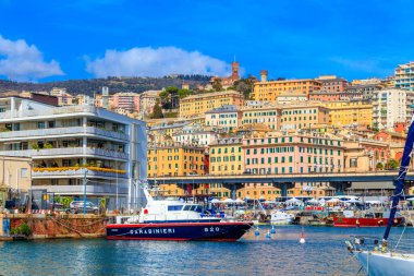 GENOA, ITALY - MARCH 9, 2019: A view on the old town and harbor with carabinieri boat in Genoa, Italy