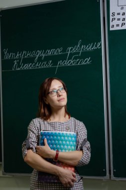 Karatahta sınıfındaki öğretmen kadın 14 Şubat 'ta ders çalışmaya başladı.
