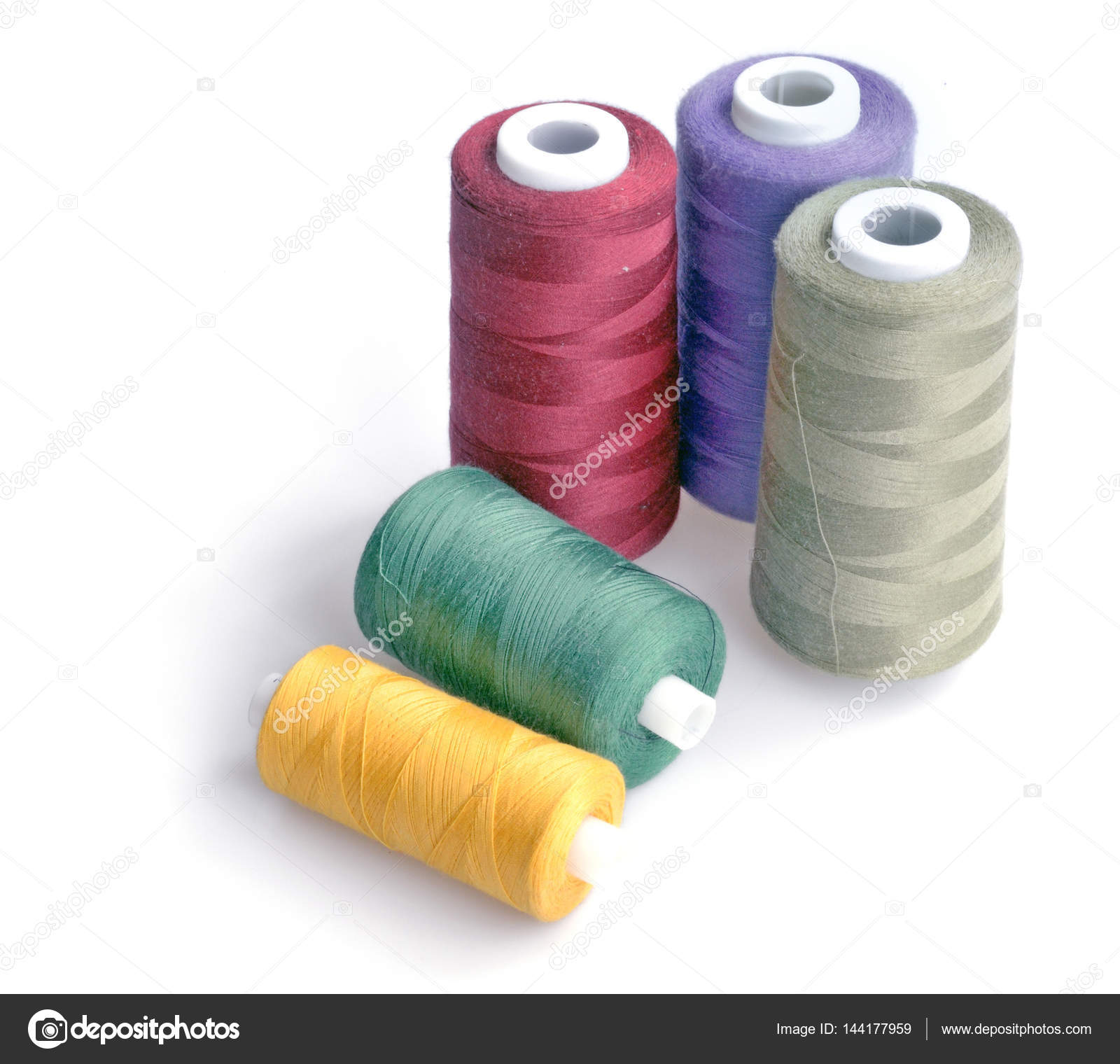 Threads for sewing of various colors on a white background isola Stock  Photo by ©avtor_hell 144177959