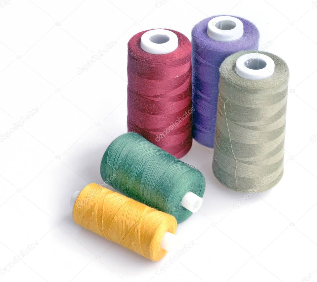 threads for sewing of various colors on a white background isola