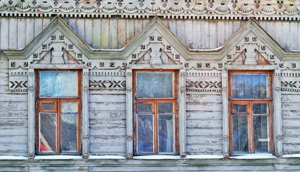 Three windows on the wall of a wooden house in the Russian style — Stock Photo, Image