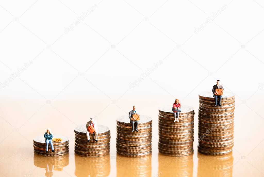 Miniature people: Elderly people sitting on coins stack. Retirement planning. money saving and Investment. Time counting down for retirement concept.