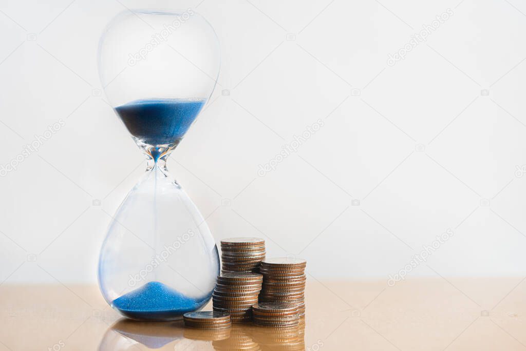 Hourglass blue sand and stack of coins. Business investment growth concept. money saving and Investment. Risk management. Time is money. Time investment and retirement saving. 401K.