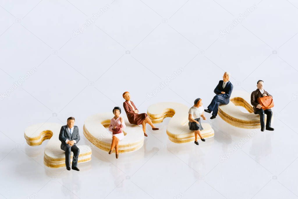 Miniature people: Elderly people sitting on word block 2020. social security income and pensions. Money saving and Investment. Time counting down for retirement concept.