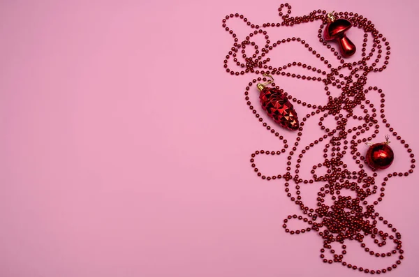 Red christmas decorations pine cone, mushroom, ball, beads on a — ストック写真