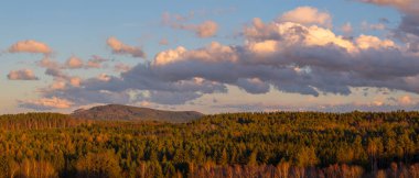 Günbatımında manzara, ormanlar, dağlar, güzel bulutlar.