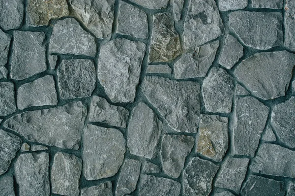 Pared de piedras texturizadas en colores oscuros — Foto de Stock
