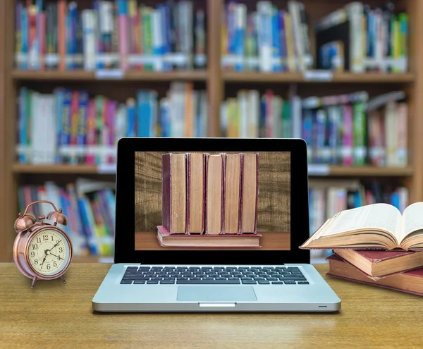 Laptop computer shows old books — Stock Photo, Image