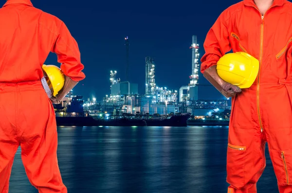 Asian engineers holding a yellow hardhats — Stock Photo, Image