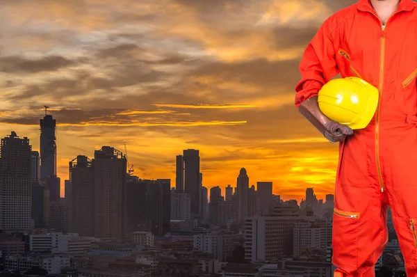 Worker holding a yellow hardhat — Stock Photo, Image