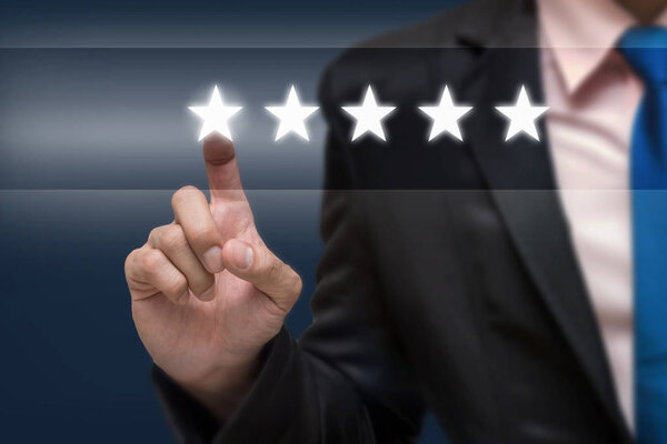 Businessman pointing five star symbol