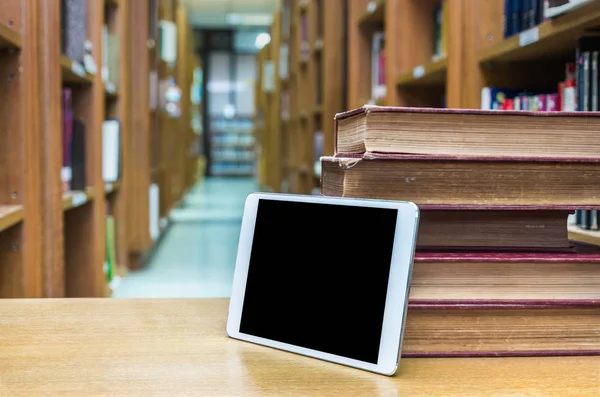 Tablet computer with old books — Stock Photo, Image