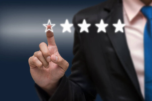 Businessman pointing five stars