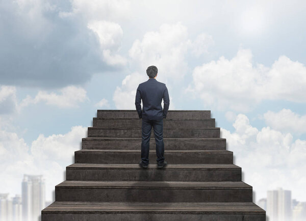 Businessman standing for walking up stairs