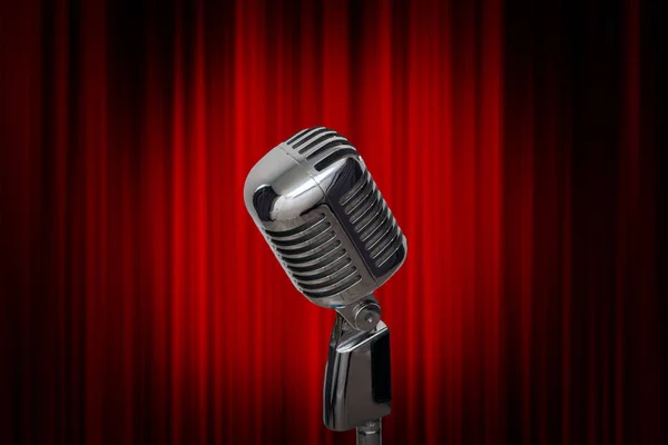 Retro microphone over the red curtain — Stock Photo, Image