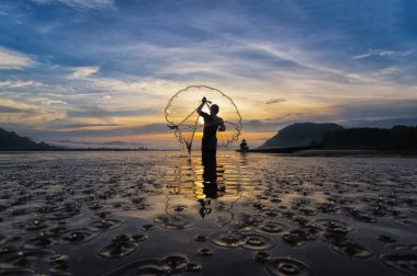 Silhouette of asia traditional fishermen clipart
