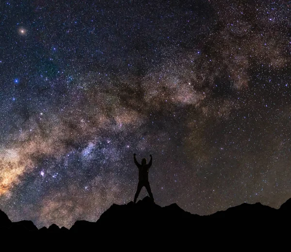 Man with raised up arms to milky way — Stock Photo, Image
