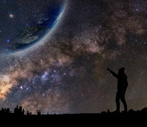 Man who standing and pointing to earth — Stock Photo, Image