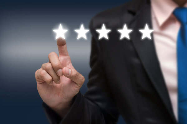 Businessman pointing five star symbol 