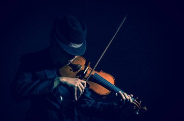  Violin player in dark studio