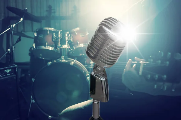 Retro microphone over the musician playing the guitar — Stock Photo, Image