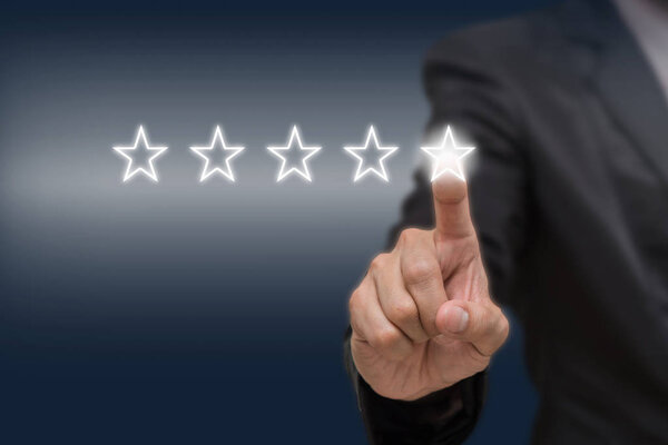 Businessman pointing five star symbol