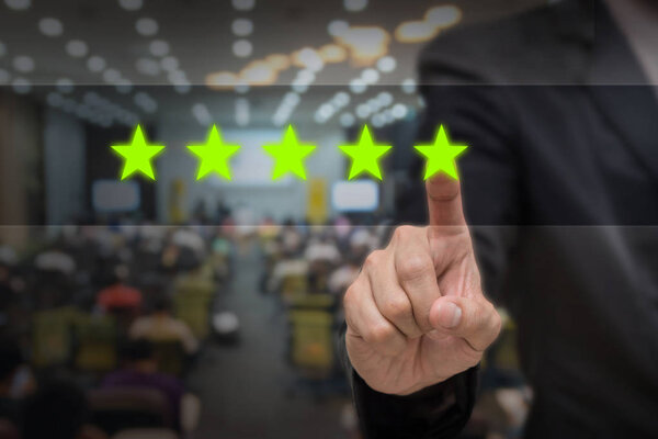 Businessman pointing five star symbol