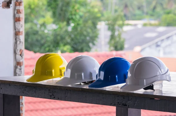 colorful safety hard hats on table