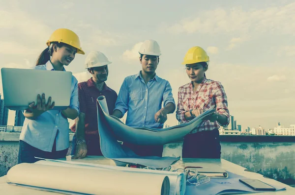 Group of professional engineers with blueprints — Stock Photo, Image